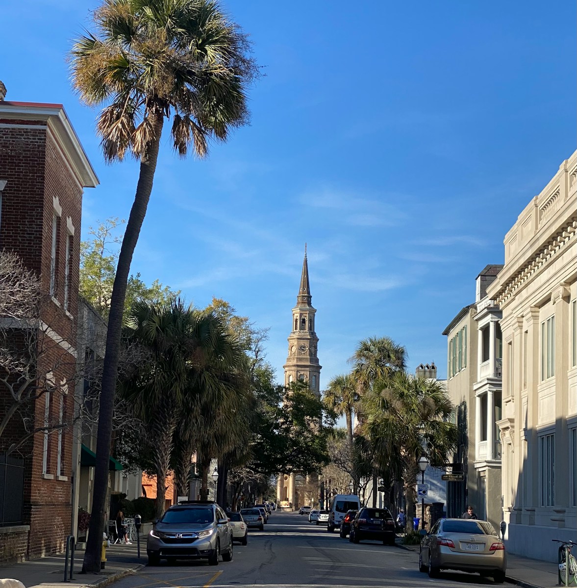 a city street with a clock tower in the background